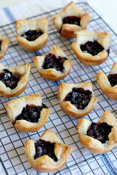 several cookies with blueberry filling on a cooling rack