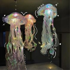 two jellyfish lights hanging from the ceiling