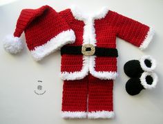 a crocheted santa suit and hat laying on top of a white surface next to a pair of black shoes