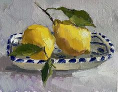 a painting of two lemons on a blue and white plate