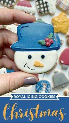 the royal icing cookies christmas cookie is decorated like a snowman with a blue hat