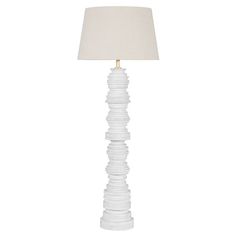 a white lamp with a beige shade on it