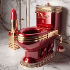 a red toilet sitting on top of a white counter next to a gold and diamond sink