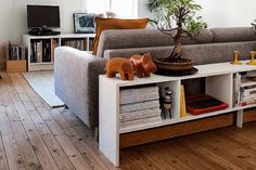 a living room filled with furniture and a potted plant on top of a table