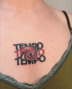 a woman with a tattoo on her chest that says tendo tempo in red and black