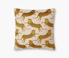 a leopard print pillow with gold foil on the front and back, sitting on a white surface