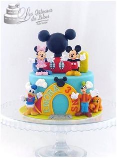 a mickey mouse birthday cake on a clear plate