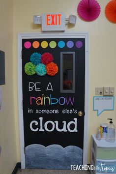 a classroom door decorated with the words be a rainbow in someone else's cloud