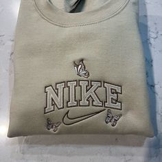 Not Nike Brand Please Allow Up To A Week To Ship Design Size Is 7x5 -Unisex Sizing True To Fit -Embroidered Design -Use Gildan Brand For Crewnecks, However There May Be A Substitute For A Similar Brand -Available In S, M, L, Xl, 2xl Size Of Design Is The Same For All Sizes Of Crewnecks So Design Will Look Smaller On A 2xl Compared To A S Material Is 50/50 Cotton/Polyester *Colors May Vary Slightly* Womens Nike Crewneck Sweatshirt, Crewneck Hoofie Nike, Nike Butterfly Shirt, Nike Butterfly Hoodie, Nike Flower Sweatshirt, Hand Embroidered Sweatshirt Nike, Crew Neck Nike Custom, Nike Pullover Embroidered, Nike Floral Embroidery Crewneck