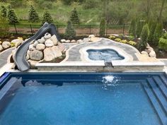 Fiberglass Pool, Water Slide, Auto Pool Cover Natural Stone Oasis Project in Northville, Michigan by Antonelli Landscape Pool & Spa Pool With Slide And Hot Tub, Rectangle Pool With Spa And Fire Pit, Pool With Slide And Waterfall, Fiberglass Pool Ideas, Stone Pool Deck, Pool Water Slide, Automatic Pool Cover