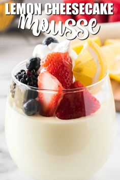 lemon cheesecake mousse in a glass with strawberries and blueberries on top