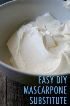 a white bowl filled with whipped cream on top of a wooden table