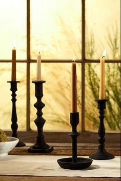 three candles sitting on top of a wooden table