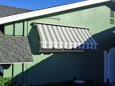 an awning on the side of a green house