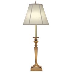 a gold lamp with a white shade on it