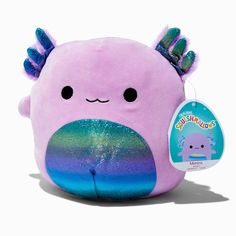 a pink stuffed animal with purple and blue hair