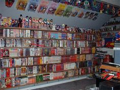 a room filled with lots of different types of toys and books on the shelves next to each other