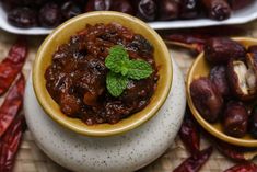 two bowls filled with food sitting on top of a table