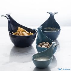 three bowls filled with food sitting on top of a white counter next to each other