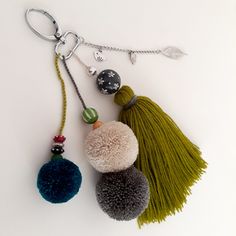 three pom poms hanging from a key chain