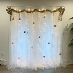 a white curtain decorated with lights and ornaments