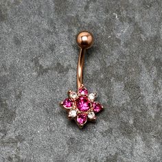 Product DetailsPink Clear Gem Rose Gold Tone Rococo Star Belly Ring You don't need to be on the silver screen look like a star when you're rocking this 14 gauge navel ring! It's made with a 3/8" rose gold tone PVD over 316L surgical grade stainless steel curved barbell with a 5mm top ball end. The bottom end features a star charm richly embellished with clear and deep pink gems for a thoroughly baroque look. Whether you're a celebrity or just have a taste for the good life, this heavenly belly p Star Navel Ring, Gold Belly Button Rings, Belly Piercing Jewelry, Belly Piercing Ring, Button Piercing, Jewelry Promotion, Gold Body Jewellery, Jewelry Piercing, Navel Ring