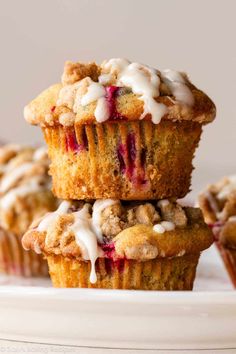 three muffins stacked on top of each other with icing and crumbs