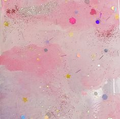 a pink background with glitter and stars on it