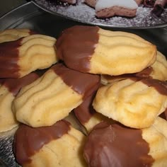 chocolate covered cookies are on a metal plate