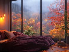 a bedroom with an open window overlooking autumn foliage