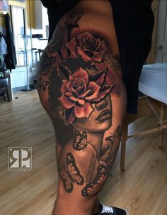 a woman's leg with flowers and butterflies on it