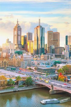 an aerial view of a city with lots of tall buildings in the background and a river running through it