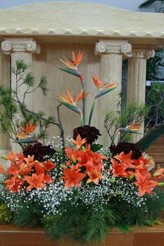 an arrangement of flowers in front of a gazebo