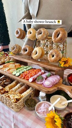 a baby shower brunch is displayed on a table with flowers and sunflowers