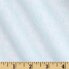 white fabric with small dots on it, and a ruler in front of the image