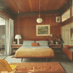 a bed room with a neatly made bed next to a window and a painting on the wall