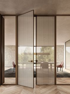 an open door leading to a dining room with chairs and table in the middle of it