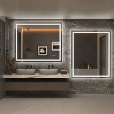 a modern bathroom with two sinks and large mirrors