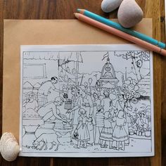 a coloring page with some rocks and pencils on the table next to it,