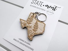 a wooden keychain with the state of texas on it