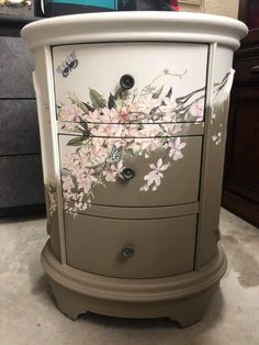 a white dresser with flowers painted on it