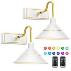 two white and gold wall lights with remotes next to them on a white background