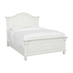 a white bed with wooden headboard and foot board on top of the bed frame