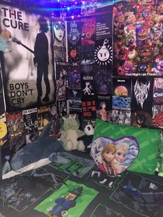 there are many posters and stuffed animals on the wall in this room, including one with a teddy bear