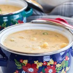 two pots filled with soup on top of a table