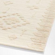 a white rug with an intricate design on the top and bottom part of it's surface