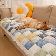 a brown dog laying on top of a couch