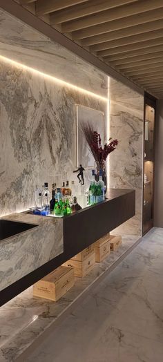 an elegant bathroom with marble walls and flooring is seen in this image, there are bottles on the counter