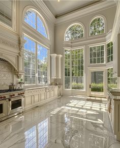 a large kitchen with marble floors and windows