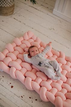 a baby laying on top of an inflatable mattress that looks like it is floating